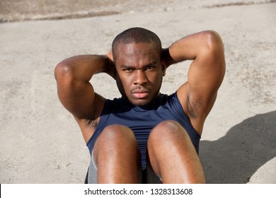 Portrait Of Healthy Young Black Man Doing Situps Outside