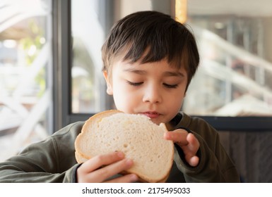 Portrait Healthy Young Boy Eating Bacon Sandwich, School Kid Having Breakfast In The Cafe Be For Go To School, Child Bitting Toast Sandwich Beef Cheddar Cheese For Lunch.