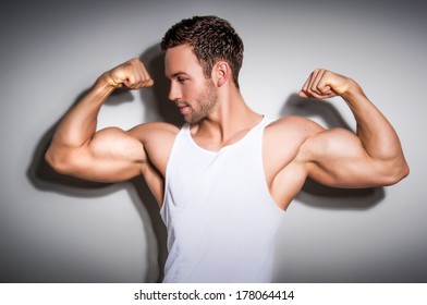 Portrait of a healthy young man showing his arms 