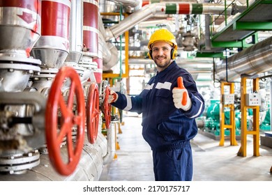 Portrait Of Heating Plant Worker Engineer Standing By Natural Gas Pipelines And Holding Thumbs Up.