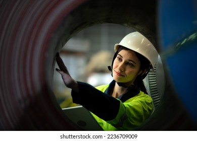Portrait heavy equipment female engineer from huge industry who came to inspect the metal sheet factory's machinery 