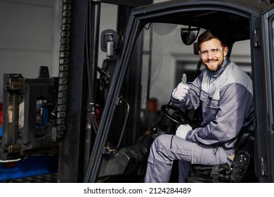 Portrait of heavy industry forklift driver giving thumbs up and smiling at the camera. - Powered by Shutterstock