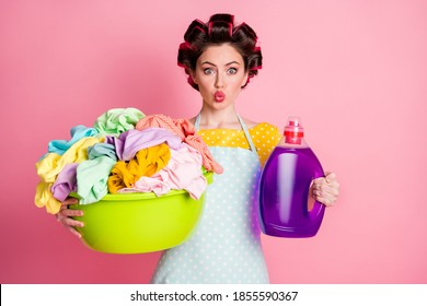Portrait of her she girlish funky amazed housemaid holding in hands chemical softener laundry stack pout lips isolated pink pastel color background