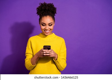Portrait of her she nice attractive lovely winsome focused cheerful cheery wavy-haired girl holding in hands device chatting on web isolated over bright vivid shine violet background