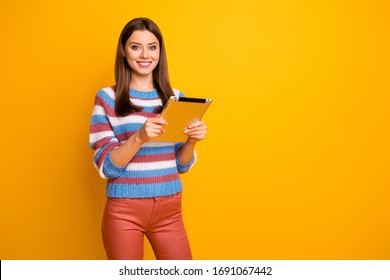 Portrait of her she nice attractive lovely pretty cute cheerful cheery brown-haired girl holding in hands using ebook app isolated over bright vivid shine vibrant yellow color background - Shutterstock ID 1691067442