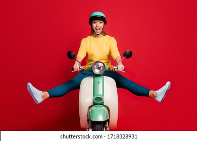 Portrait of her she nice attractive lovely funny glad cheerful cheery girl driving moped traveling having fun fooling isolated on bright vivid shine vibrant red color background