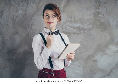 Portrait Of Her She Nice Attractive Pretty Creative Focused Wavy-haired Girl Writing Memo Planner Organizer Overthinking Isolated On Gray Concrete Industrial Wall Background