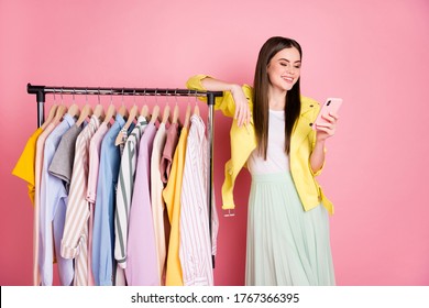 Portrait of her she nice attractive lovely cheerful girl using cell looking searching finding ordering apparel fast delivery deliver isolated on bright vivid shine vibrant yellow color background