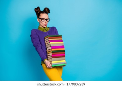 Portrait of her she nice attractive pretty smart clever tired girl geek carrying big large heavy pile books isolated on bright vivid shine vibrant blue green teal turquoise color background - Powered by Shutterstock