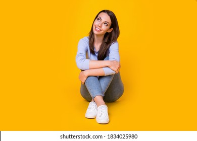 Portrait of her she nice attractive lovely pretty dreamy cheerful cheery girl sitting on floor creating new solution copy space clue guess isolated bright vivid shine vibrant yellow color background - Powered by Shutterstock