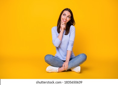 Portrait of her she nice attractive brainy smart clever cheerful girl sitting, lotus position thinking making decision copy space clue guess isolated bright vivid shine vibrant yellow color background