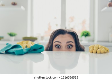 Portrait of her she nice cute lovely beautiful girlish funny shocked wavy-haired house-wife hiding behind shine glossy table in modern light white interior indoors