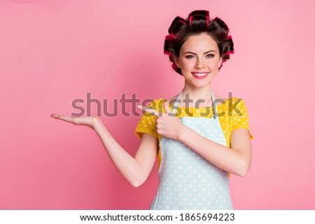 Portrait of her she nice pretty confident cheerful housewife holding on palm copy empty space advice isolated over pink pastel color background