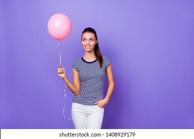 Portrait of her she nice-looking attractive lovely charming cute winsome cheerful cheery feminine girl holding in hand pink helium ball isolated over violet purple vivid shine bright background