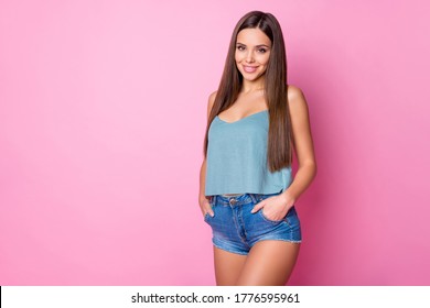Portrait of her she nice-looking attractive lovely cute gorgeous lovable winsome cheerful cheery brown-haired girl holding hands in pockets posing isolated over pink pastel color background