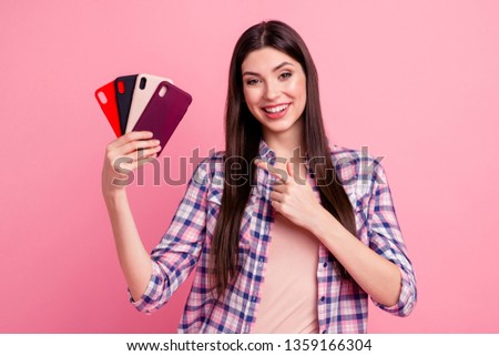 Portrait of her she nice-looking attractive cute charming lovely cheerful straight-haired lady holding in hands showing cool new fashionable cases sale discount ad isolated over pink background