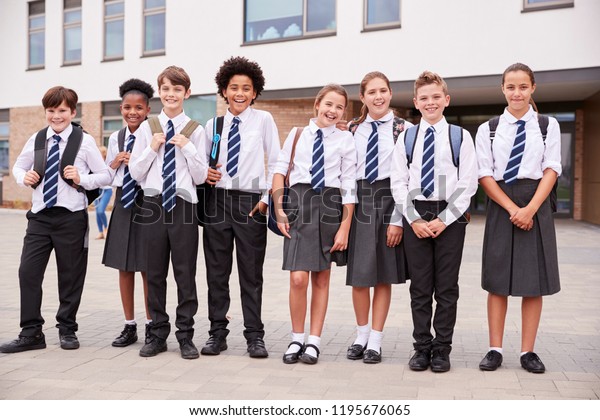 Portrait Of High School Student Group\
Wearing Uniform Standing Outside School\
Buildings