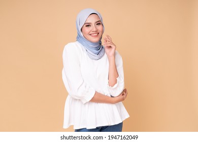 Portrait Of Hijab Girl Smiling. Pretty Muslim Girl. Beautiful Asian Muslimah Woman Model Posing On Beige Background Studio.