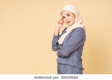 Portrait Of Hijab Girl Smiling. Pretty Muslim Girl. Beautiful Asian Muslimah Woman Model Posing On Beige Background Studio.