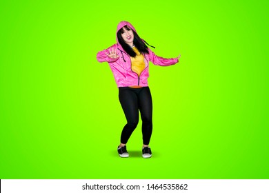 Portrait Of Hip Hop Dancer Performing In The Studio With Green Screen Background