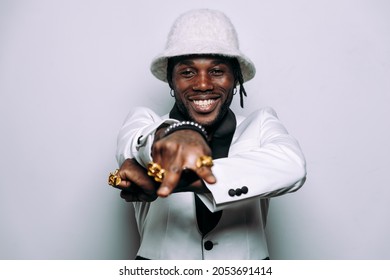 Portrait Of An Hip Hop Music Musician. Cinematic Image Of A Man Wearing White Clothes And Jewels