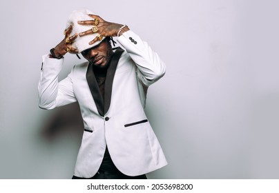 Portrait Of An Hip Hop Music Musician. Cinematic Image Of A Man Wearing White Clothes And Jewels