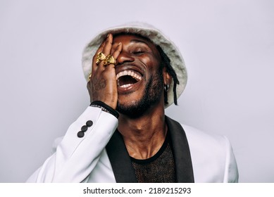 Portrait Of An Hip Hop Music Musician. Cinematic Image Of A Man Wearing White Clothes And Jewels