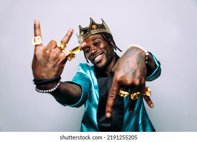 Portrait Of An Hip Hop Music Musician. Cinematic Image Of A Man Wearing Party Clothes And Jewels