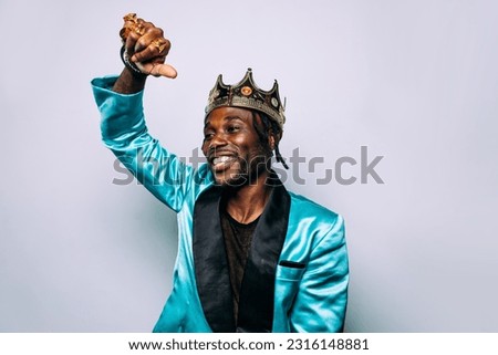 portrait of an hip hop music musician. Cinematic image of a man wearing party clothes and jewels
