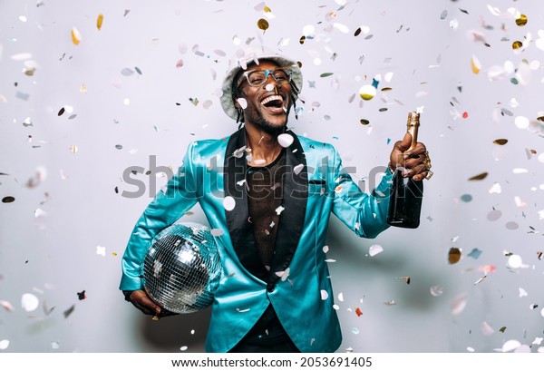 portrait of an hip hop music musician.
Cinematic image of a man under confetti
drop