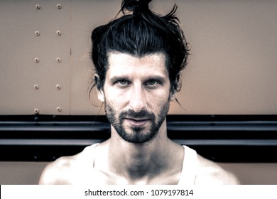 Portrait Of A Hipster Man With Man Bun And Piercing 