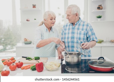 Portrait of his he her she nice attractive concentrated focused careful helpful spouses cooking fresh delicious new domestic dishes pasta soup in modern light white interior kitchen indoors - Powered by Shutterstock