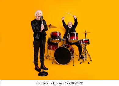 Portrait of his he her she nice attractive cheerful excited grey-haired couple performing singing playing live show scene fame isolated over bright vivid shine vibrant yellow color background