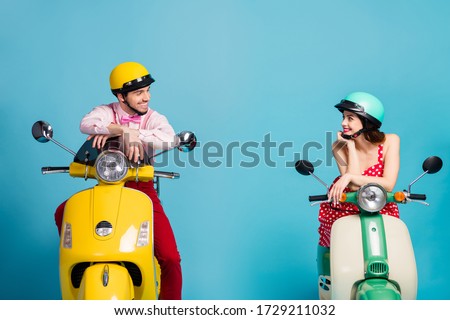 Portrait of his he her she nice attractive lovely cheerful cheery couple sitting on moped wearing festal look communicating isolated on bright vivid shine vibrant blue color background