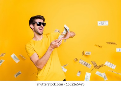 Portrait of his he nice attractive glad cheerful cheery guy throwing away large sum of money budget finance freedom isolated over bright vivid shine vibrant yellow color background