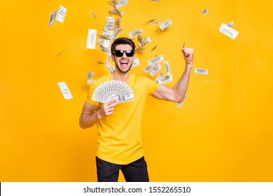 Portrait of his he nice attractive content cheerful cheery guy throwing away large sum of money budget great luck isolated over bright vivid shine vibrant yellow color background