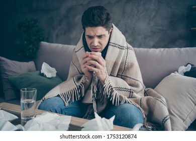 Portrait Of His He Nice Attractive Sick Guy Sitting On Divan Taking Drugs Drinking Green Herbal Tea Beverage Healing Weakened Immunity Disease At Modern Industrial Loft Concrete Interior Style