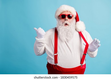 Portrait of his he nice attractive amazed stunned white-haired Santa demonstrating copy space advert ad solution decision pulling suspender isolated bright vivid shine vibrant blue color background - Powered by Shutterstock