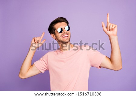 Portrait of his he nice attractive cute cool cheerful cheery glad bearded brunet guy wearing pink tshirt dancing having fun isolated on violet purple lilac pastel color background