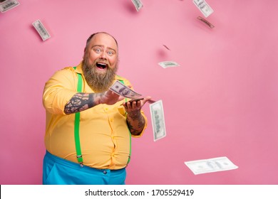 Portrait of his he nice cheerful cheery glad lucky bearded guy throwing away income interest deposit winning cashback isolated over pink pastel color background