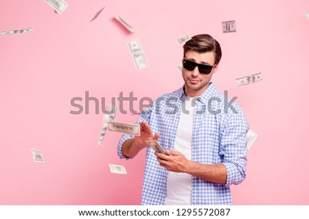 Portrait of his he nice cool trendy content attractive handsome reckless careless carefree guy wearing checked shirt throwing money away wealth isolated over pink pastel background