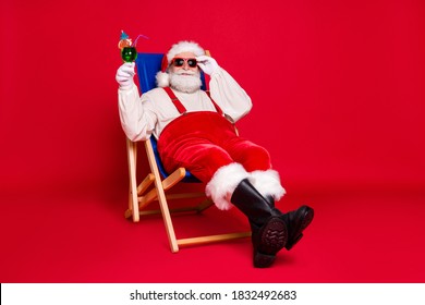 Portrait of his he nice handsome cheery bearded fat Santa father hipster guy sitting in chair relax chill out spending weekend leisure isolated bright vivid shine vibrant red color background - Powered by Shutterstock