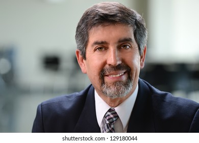 Portrait of Hispanic businessman smiling indoors
