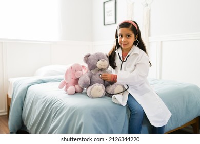 Portrait of an hispanic elementary girl making eye contact and smiling while dreaming of becoming a doctor - Powered by Shutterstock