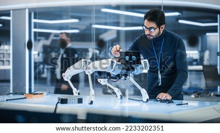 Portrait of Hispanic Engineer Using a Screwdriver While Building and Developing a Robot Dog Concept. Multiethnic Specialist Working in High Tech Research Laboratory with Modern Equipment.