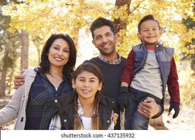 Portrait Of Hispanic Family Outdoors Looking At Camera