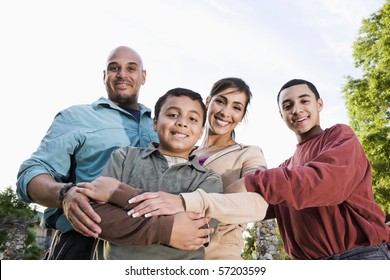 Portrait Of Hispanic Family With Two Boys Outdoors