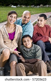 Portrait Of Hispanic Family With Two Boys Outdoors