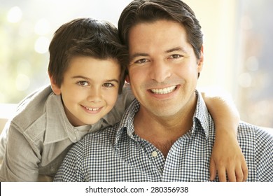 Portrait Of Hispanic Father And Son At Home