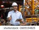 Portrait Hispanic Indian construction engineer male worker at construction site with safety hard hat and tablet computer happy smiling thumbs up